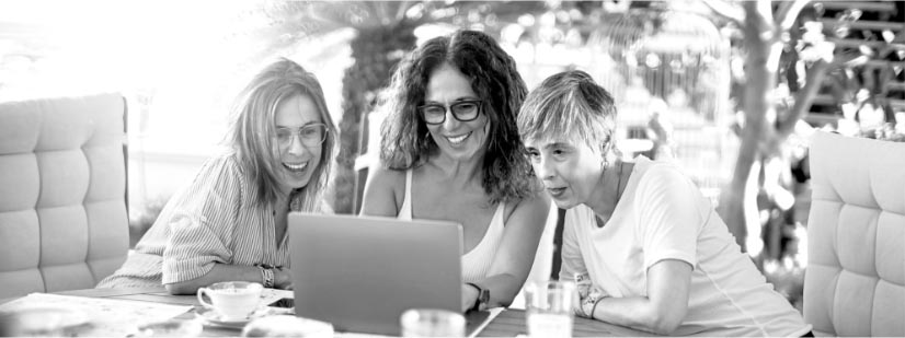 group of women looking at laptop